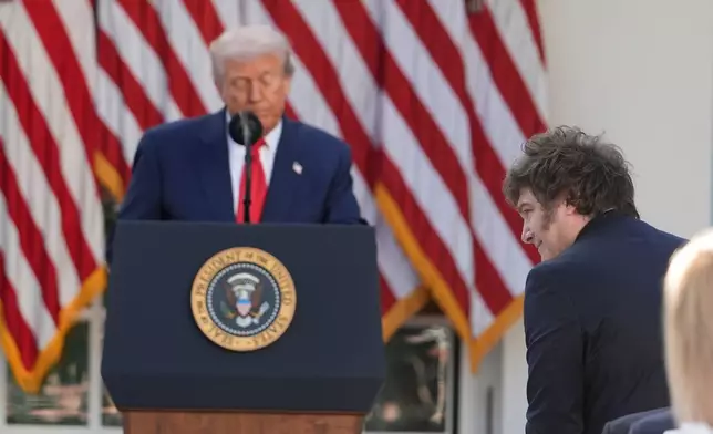 Argentina's President Javier Milei stands as President Donald Trump recognizes him as he speaks before posthumously awarding the Presidential Medal of Freedom to Charlie Kirk in the Rose Garden of the White House, Tuesday, Oct. 14, 2025, in Washington. (AP Photo/Alex Brandon)