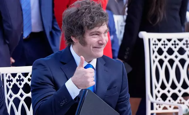 Argentina's President Javier Milei, is seated before President Donald Trump arrives to present the Presidential Medal of Freedom for Charlie Kirk to his widow Erika Kirk in the Rose Garden of the White House, Tuesday, Oct. 14, 2025, in Washington. (AP Photo/Mark Schiefelbein)