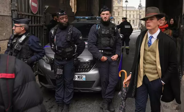 Police officers block an access to the Louvre museum after a robbery Sunday, Oct. 19, 2025, in Paris. (AP Photo/Thibault Camus)