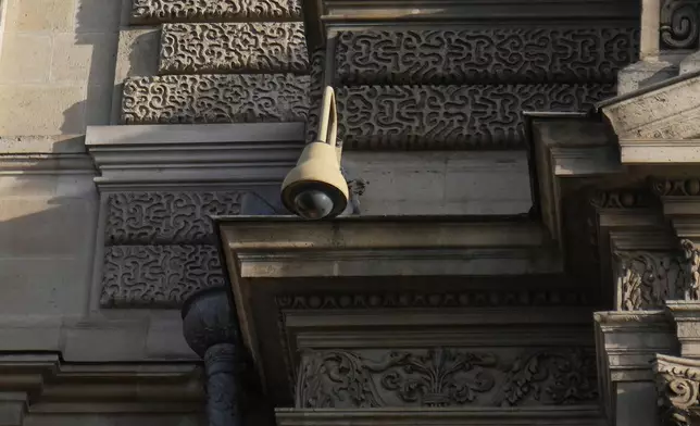 A surveillance camera is seen on a facade of the Louvre museum, three days after historic jewels were stolen in a daring daylight heist, Wednesday, Oct. 22, 2025 in Paris. (AP Photo/Thibault Camus)