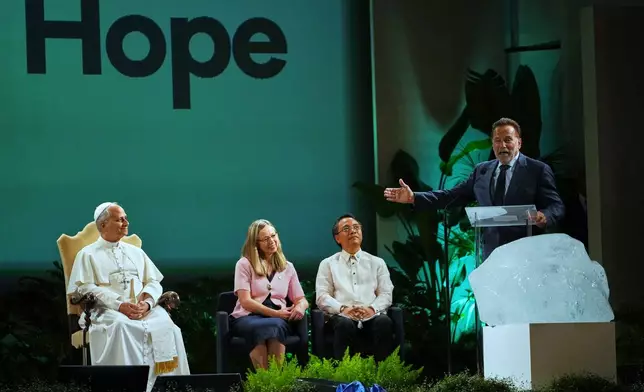 Arnold Schwarzenegger, right, delivers his speech at the International conference "Raising Hope for Climate Justice" attended by Pope Leo XIV, in Castel Gandolfo, Italy, Wednesday, Oct. 1, 2025. (AP Photo/Alessandra Tarantino)