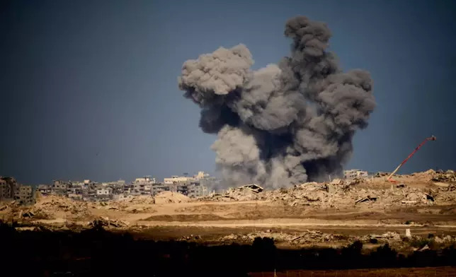Smoke rises to the sky following an Israeli military strike in the Gaza Strip, as seen from southern Israel, Friday, Oct. 10, 2025, after Israel and Hamas have agreed to a pause in their war and the release of the remaining hostages. (AP Photo/Emilio Morenatti)