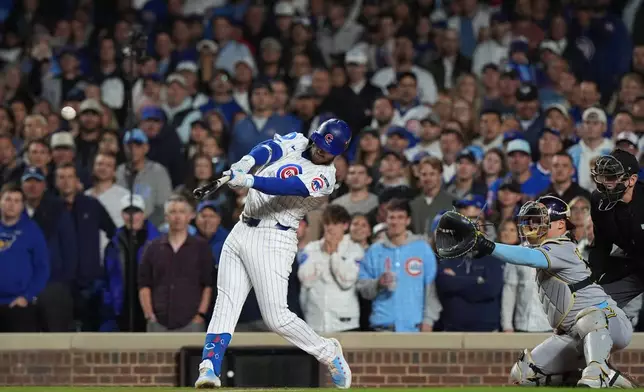 Chicago Cubs' Ian Happ (8) hits a 3-run home run during the first inning of Game 4 of baseball's National League Division Series against the Milwaukee Brewers Thursday, Oct. 9, 2025, in Chicago. (AP Photo/Nam Y. Huh)