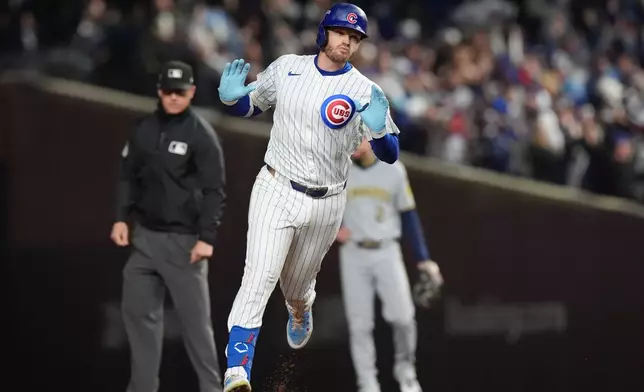 Chicago Cubs' Ian Happ (8) runs the bases after hitting a 3-run home run during the first inning of Game 4 of baseball's National League Division Series against the Milwaukee Brewers Thursday, Oct. 9, 2025, in Chicago. (AP Photo/Nam Y. Huh)