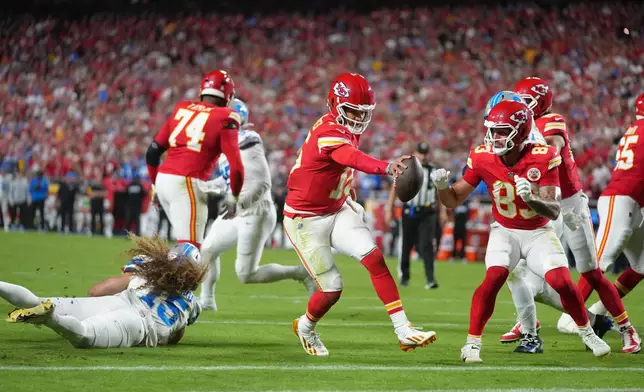 Kansas City Chiefs quarterback Patrick Mahomes (15) scores on a 1-yard run during the first half of an NFL football game against the Detroit Lions Sunday, Oct. 12, 2025, in Kansas City, Mo. (AP Photo/Ed Zurga)