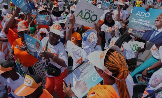 Supporters of President Alassane Ouattara dance during a rally in Abidjan, Ivory Coast, Thursday, Oct. 23, 2025. (AP Photo/Misper Apawu)