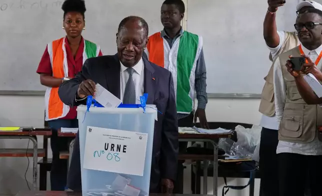Ivory Coast President Alassane Ouattara casts his vote at a polling station during the presidential elections in Abidjan, Ivory Coast, Saturday, Oct. 25, 2025. (AP Photo/Misper Apawu)