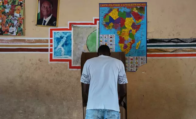 A man casts his ballot during the presidential elections in Abidjan, Ivory Coast, Saturday, Oct. 25, 2025. (AP Photo/Misper Apawu)