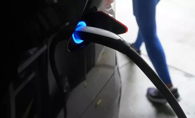 FILE - A Tesla car charges at a home in San Francisco, Aug. 25, 2022. (AP Photo/Jeff Chiu, File)