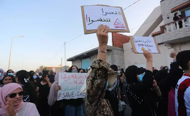 People take part in a demonstration against pollution caused by chemical factories, in Gabes, Tunisia, Wednesday, Oct. 16, 2025. Banner in Arabic reads "We would like to breathe." (AP Photo/Bassem Aouini)