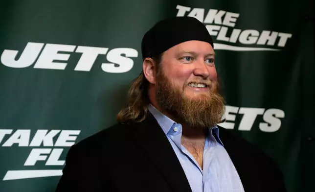 FILE - Former New York Jets center Nick Mangold poses for photographers on the green carpet ahead of an event unveiling the team's new NFL football uniforms, Thursday, April 4, 2019, in New York. (AP Photo/Julio Cortez, File)