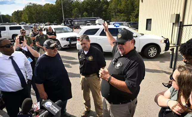 Humphreys County Sheriff Chris Davis, right, stands next to Hickman County Sheriff J. Craft as they address the press during a news conference at Accurate Energetic Systems, an explosives plant, after a blast resulted in multiple fatalities and others missing Friday, Oct. 10, 2025, in Bucksnort, Tenn. (AP Photo/John Amis)