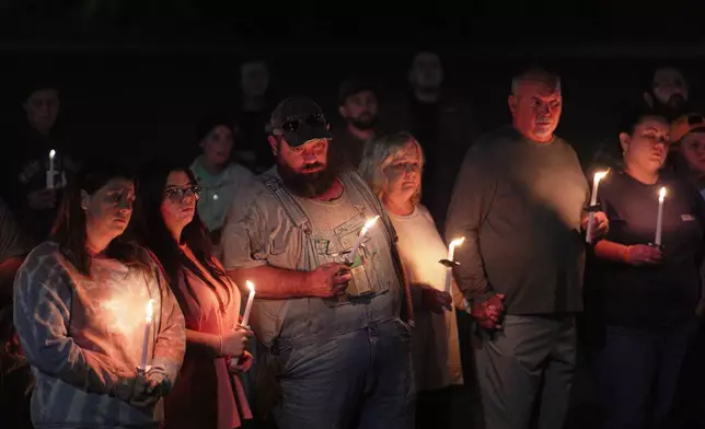 Residents attend a vigil honoring the victims of a blast at an explosives plant, Accurate Energetic Systems, on Friday, Oct. 10, 2025, in Centerville Tenn. (AP Photo/Obed Lamy)