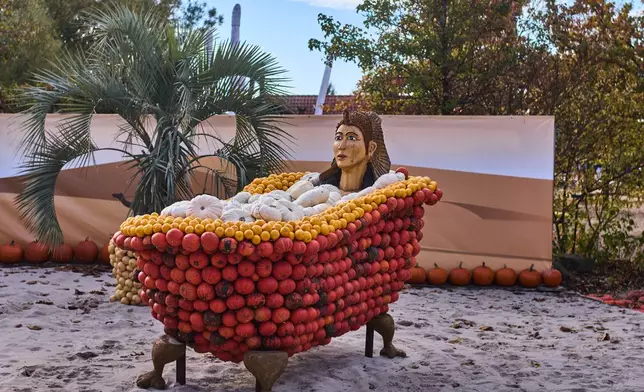 A pumpkin sculpture depicting Cleopatra, is displayed at Klaistow farm’s annual pumpkin festival, which this year celebrates “powerful women,” in Beelitz near Berlin, Germany, Tuesday, Oct. 21, 2025. (AP Photo/Markus Schreiber)
