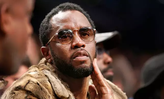 FILE - Sean "Diddy" Combs sits courtside in the second half of an NBA basketball game between the Brooklyn Nets and the New York Knicks, March 12, 2017, in New York. (AP Photo/Kathy Willens, File)
