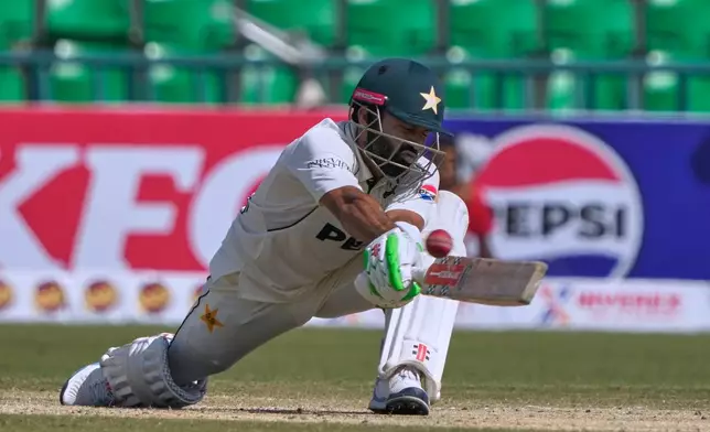 Pakistan's Mohammad Rizwan plays a shot during the second day of the first test cricket match between Pakistan and South Africa, in Lahore, Pakistan, Monday, Oct. 13, 2025. (AP Photo/K.M. Chaudary)