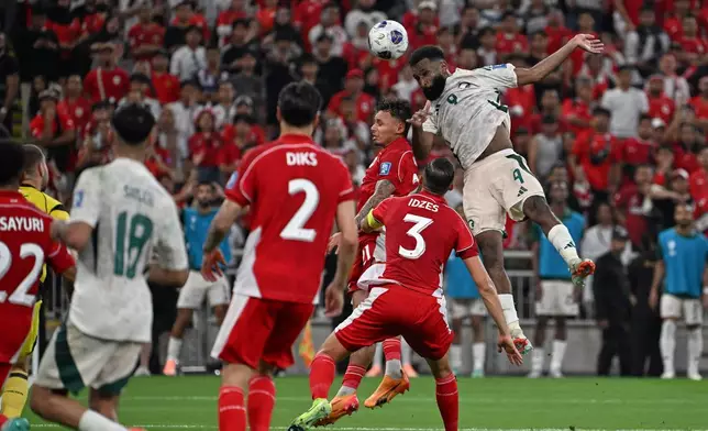 Saudi Arabia's Feras Albrikan, right, heads the ball to scores his side's third goal during the World Cup 2026 Asian qualifier fourth-round Group B soccer match between Saudi Arabia and Indonesia at Alinma Bank Stadium in King Abdullah Sports City, in Jiddah, Saudi Arabia, Wednesday, Oct. 8, 2025. (AP Photo)