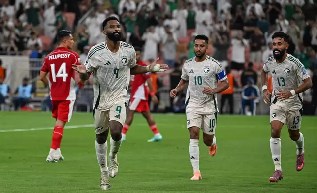Saudi Arabia's Feras Albrikan, left, celebrates after scoring his side's opening goal during the World Cup 2026 Asian qualifier fourth-round Group B soccer match between Saudi Arabia and Indonesia at Alinma Bank Stadium in King Abdullah Sports City, in Jiddah, Saudi Arabia, Wednesday, Oct. 8, 2025. (AP Photo)