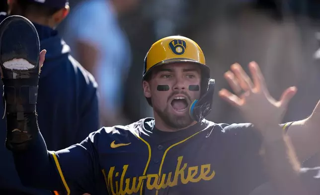 Milwaukee Brewers' Caleb Durbin celebrates after scoring against the Los Angeles Dodgers during the second inning in Game 3 of baseball's National League Championship Series, Thursday, Oct. 16, 2025, in Los Angeles. (AP Photo/Brynn Anderson)