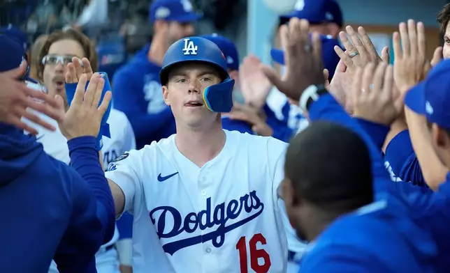 Los Angeles Dodgers' Will Smith celebrates in the dugout after scoring against the Milwaukee Brewers during the seventh inning in Game 3 of baseball's National League Championship Series, Thursday, Oct. 16, 2025, in Los Angeles. (AP Photo/Ashley Landis)