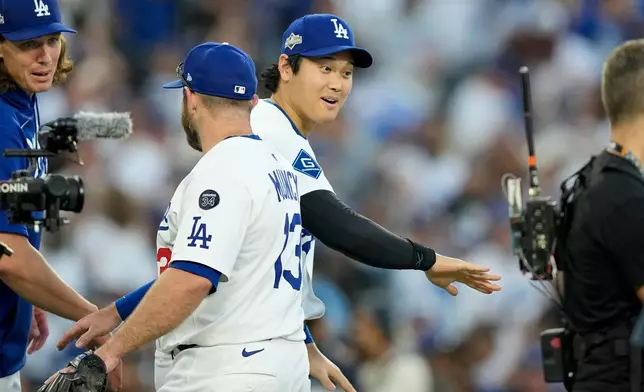 Los Angeles Dodgers' Shohei Ohtani celebrates their win against the Milwaukee Brewers in Game 3 of baseball's National League Championship Series, Thursday, Oct. 16, 2025, in Los Angeles. (AP Photo/Brynn Anderson)