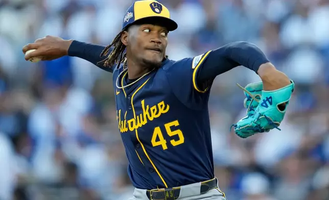 Milwaukee Brewers pitcher Abner Uribe throws against the Los Angeles Dodgers during the seventh inning in Game 3 of baseball's National League Championship Series, Thursday, Oct. 16, 2025, in Los Angeles. (AP Photo/Ashley Landis)