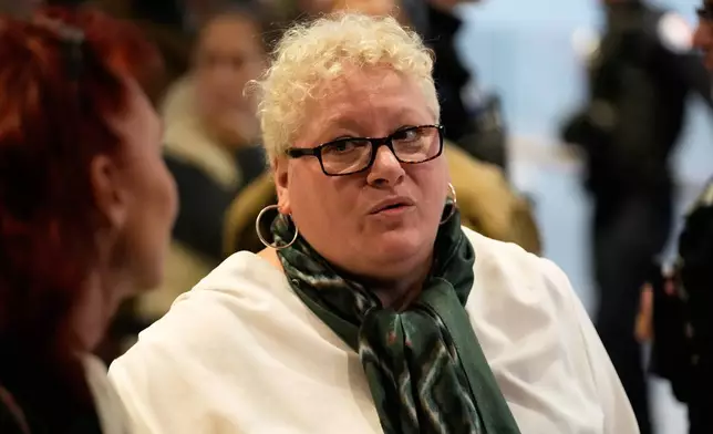 Defendant Delphine Jegousse known as Amandine Roy, arrives at the courtroom as ten people go on trial over cyberbullying of Brigitte Macron after they allegedly made "malicious" comments online spreading claims that President Emmanuel Macron 's wife is a man. Monday, Oct. 27, 2025 in Paris. (AP Photo/Michel Euler)