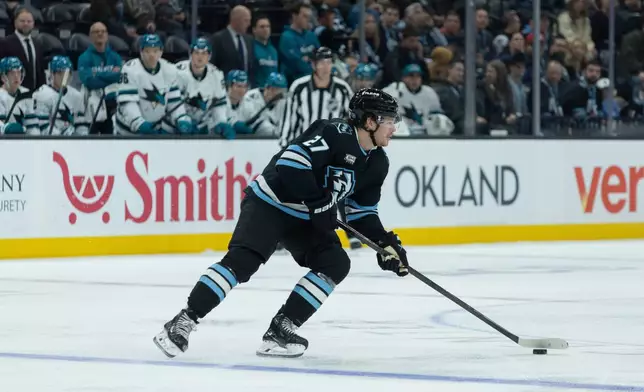 Utah Mammoth center Barrett Hayton (27) skates with the puck against San Jose Sharks during the first period of an NHL hockey game Friday, Oct. 17, 2025, in Salt Lake City. (AP Photo/Melissa Majchrzak)