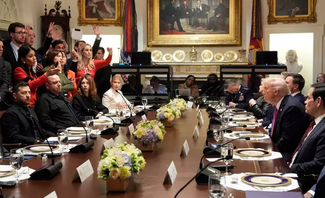 President Donald Trump, second right, and Ukraine's President Volodymyr Zelenskyy, seated left, sit as reporters as questions before a lunch in the Cabinet Room of the White House, Friday, Oct. 17, 2025, in Washington. (AP Photo/Alex Brandon)