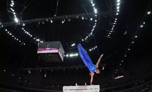 Mamikon Khachatryan of Armenia competes in the men's pommel horse final during the 53rd Artistic Gymnastics World Championships in Jakarta, Indonesia, Friday, Oct. 24, 2025. (AP Photo/Dita Alangkara)