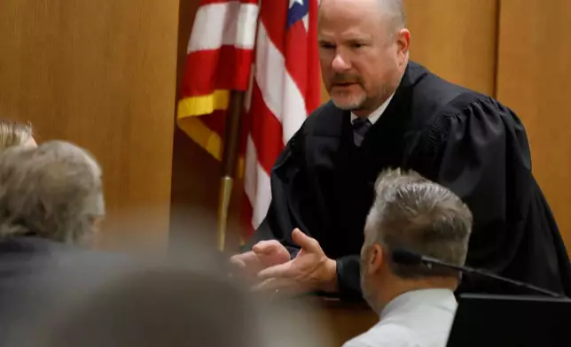 Newport News Circuit Court Judge Matthew Hoffman sidebars with attorneys during Former Richneck Elementary School teacher Abby Zwerner's civil lawsuit against the former assistant principal of the school where Zwerner was shot, Tuesday, Oct. 28, 2025, in Newport News, Va. (Stephen M. Katz/The Virginian-Pilot via AP, Pool)