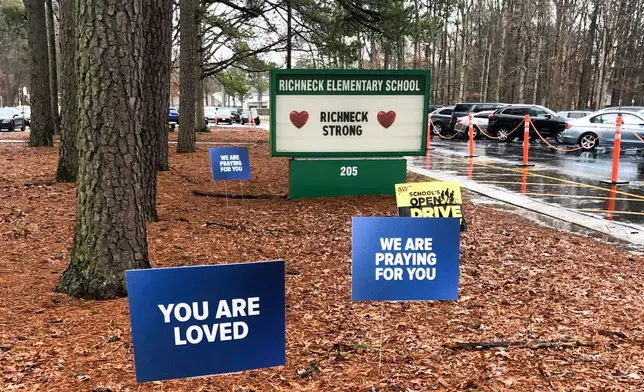 FILE - Signs stand outside Richneck Elementary School in Newport News, Va., Jan. 25, 2023. (AP Photo/Denise Lavoie, File)