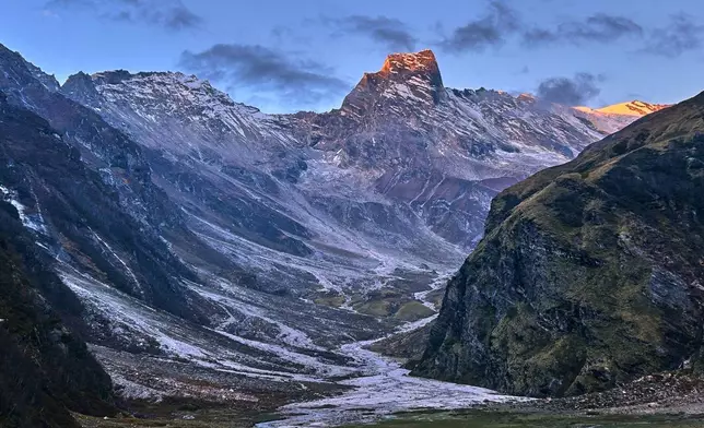 The morning sun illuminates Bankatiya Peak near Laspa village, in the northern Indian Himalayan state of Uttarakhand, on Sept. 28, 2025. (AP Photo/Satish Sharma)
