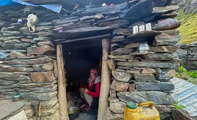 Prema Devi cooks inside her small eatery, catering to trekkers passing through on their way to the Nanda Devi Base Camp, in Ghanghar village, in the northern Indian Himalayan state of Uttarakhand, on Oct. 1, 2025. (AP Photo/Satish Sharma)