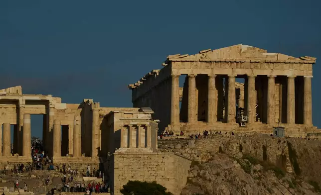 The 5th century B.C. Parthenon temple, right stands free of scaffolding on the Acropolis hill in Athens, Friday, Oct. 10, 2025, after the removal of restoration structures that had covered parts of the ancient monument for decades.(AP Photo/Petros Giannakouris)