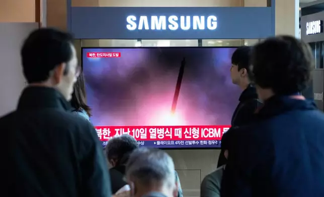 A TV screen shows a file image of North Korea's missile launch during a news program at Seoul Railway Station in Seoul, South Korea, Wednesday, Oct. 22, 2025. (AP Photo/Ahn Young-joon)
