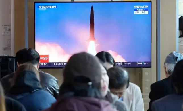 A TV screen shows a file image of North Korea's missile launch during a news program at Seoul Railway Station in Seoul, South Korea, Wednesday, Oct. 22, 2025. (AP Photo/Ahn Young-joon)