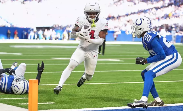 Arizona Cardinals' Greg Dortch runs after a catch for a touchdown during the second half of an NFL football game against the Indianapolis Colts Sunday, Oct. 12, 2025, in Indianapolis. (AP Photo/Michael Conroy)