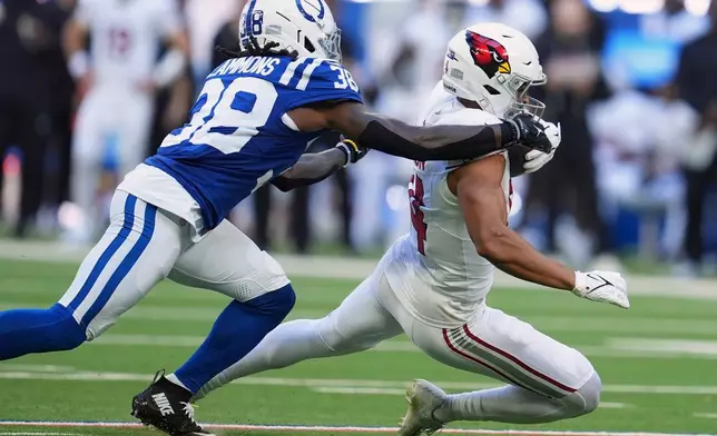 Indianapolis Colts Chris Lammons stops Arizona Cardinals' Michael Wilson during the second half of an NFL football game Sunday, Oct. 12, 2025, in Indianapolis. (AP Photo/Michael Conroy)