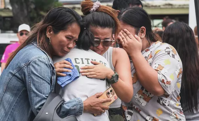 People grieve after identifying the body of a victim outside Cebu Provincial Hospital in Bogo City, Wednesday, Oct. 1, 2025. (AP Photo/Jacqueline Hernandez)