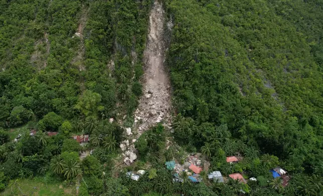 Damaged homes lie after a landslide caused by Tuesday's strong earthquake killed some people sleeping in their hillside homes, Thursday, Oct. 2, 2025, in Bogo city, Cebu Province, Central Philippines. (AP Photo/Aaron Favila)