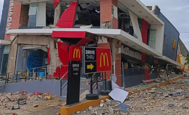 A damaged McDonald's store is seen in Bogo City, Cebu province, Philippines Wednesday, Oct. 1, 2025 after an offshore earthquake on late Tuesday. (AP Photo/Rufino Alub)