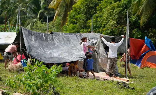 Survivors of Tuesday's earthquake build tents at open spaces on Thursday, Oct. 2, 2025 in San Remigio, Cebu Province, Central Philippines. (AP Photo/Aaron Favila)