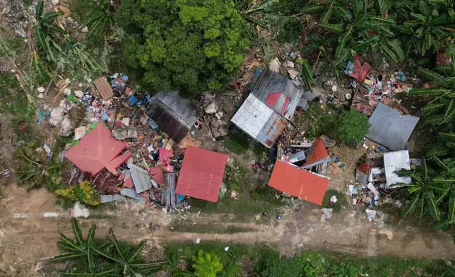 Damaged homes lie after a landslide caused by Tuesday's strong earthquake killed some people sleeping in their hillside homes, Thursday, Oct. 2, 2025, in Bogo city, Cebu Province, Central Philippines. (AP Photo/Aaron Favila)