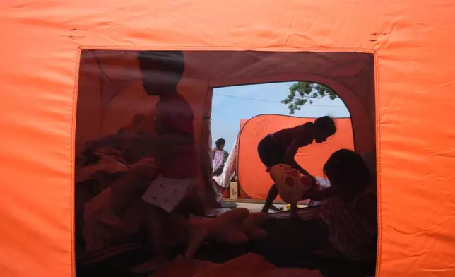 Earthquake survivors stay in tents on Thursday, Oct. 2, 2025 after Tuesday's strong quake in San Remigio, Cebu Province, Central Philippines. (AP Photo/Aaron Favila)