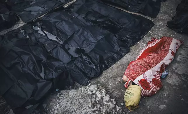 Bodies of victims of an earthquake lay outside Cebu Provincial Hospital in Bogo City, Philippines, Wednesday, Oct. 1, 2025. (AP Photo/Jacqueline Hernandez)