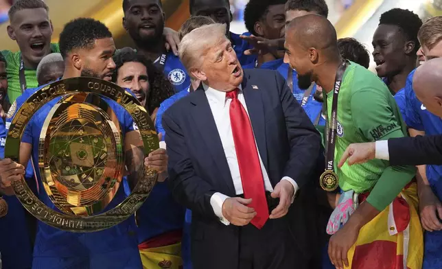 FILE - President Donald Trump, center, speaks with Chelsea's goalkeeper Robert Sanchez, right, as Chelsea's Reece James holds the championship trophy following the Club World Cup final soccer match in East Rutherford, N.J., July 13, 2025. (AP Photo/Jacquelyn Martin, File)