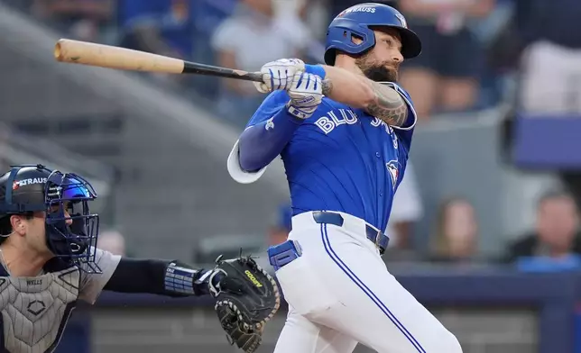 Toronto Blue Jays' Nathan Lukes (38) hits a two-run double against the New York Yankees during the seventh inning in Game 1 of baseball's American League Division Series, Saturday, Oct. 4, 2025, in Toronto. (Frank Gunn/The Canadian Press via AP)