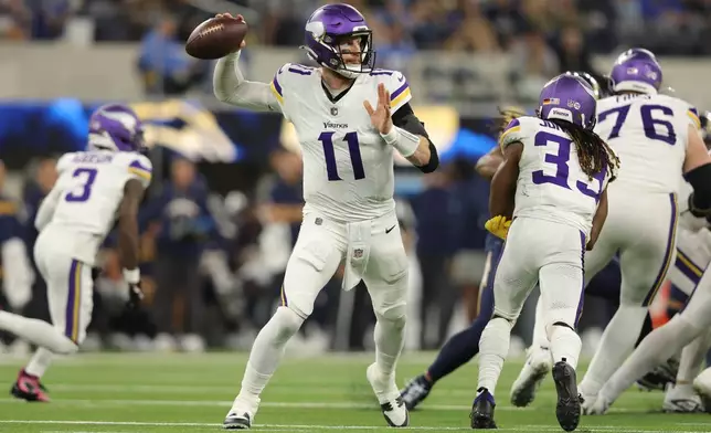 Minnesota Vikings quarterback Carson Wentz (11) passes during the second half of an NFL football game against the Los Angeles Chargers Thursday, Oct. 23, 2025, in Inglewood, Calif. (AP Photo/Jessie Alcheh)