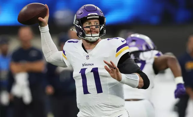 Minnesota Vikings quarterback Carson Wentz (11) passes first half of an NFL football game against the Los Angeles Chargers Thursday, Oct. 23, 2025, in Inglewood, Calif. (AP Photo/Jessie Alcheh)